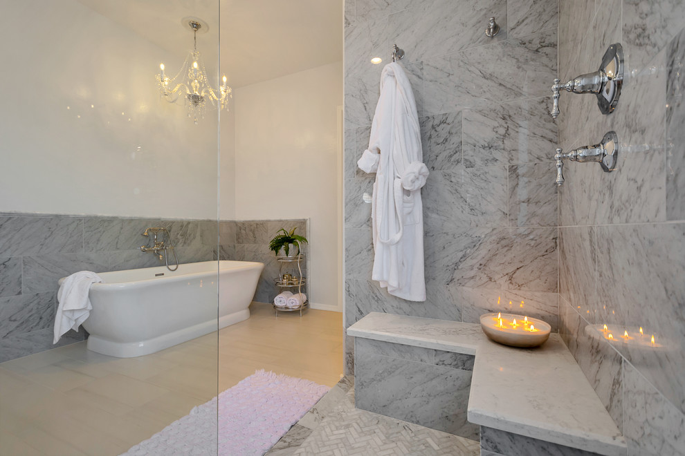 Large transitional master gray tile and marble tile porcelain tile and gray floor freestanding bathtub photo in Phoenix with recessed-panel cabinets, white cabinets, gray walls, a drop-in sink, quartz countertops and white countertops