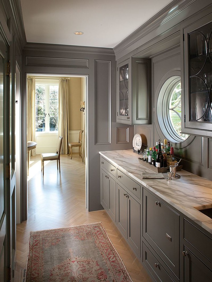 Mid-sized contemporary galley wet bar in San Francisco with an undermount sink, shaker cabinets, grey cabinets, soapstone benchtops, grey splashback and porcelain floors.