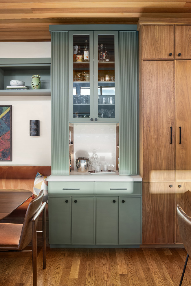Inspiration for a mid-sized 1950s l-shaped medium tone wood floor and brown floor dry bar remodel in Seattle with shaker cabinets, medium tone wood cabinets, quartz countertops, white backsplash, mosaic tile backsplash and white countertops