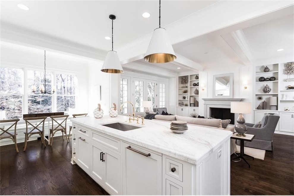 Large country l-shaped open plan kitchen in Atlanta with an undermount sink, recessed-panel cabinets, white cabinets, marble benchtops, white splashback, ceramic splashback, panelled appliances, dark hardwood floors and with island.