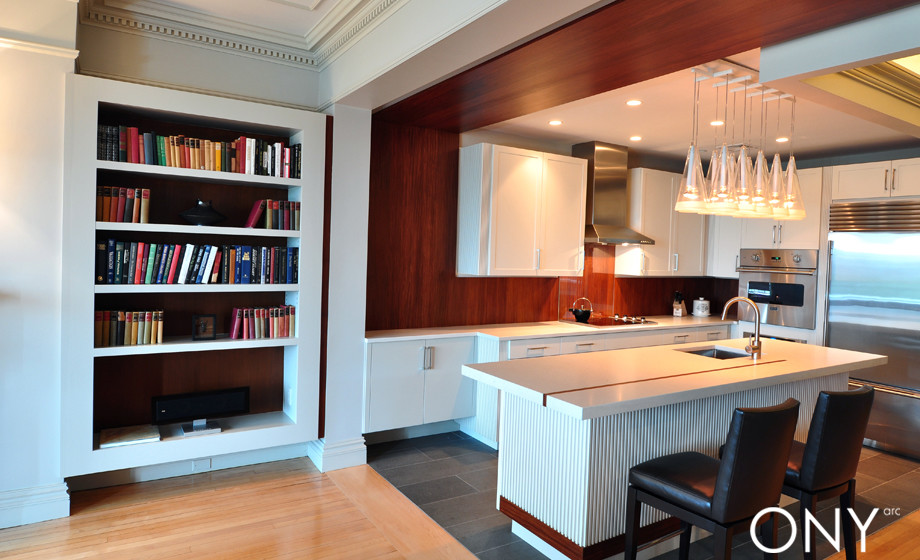Mid-sized transitional l-shaped limestone floor eat-in kitchen photo in Boston with an undermount sink, shaker cabinets, white cabinets, quartzite countertops and stainless steel appliances