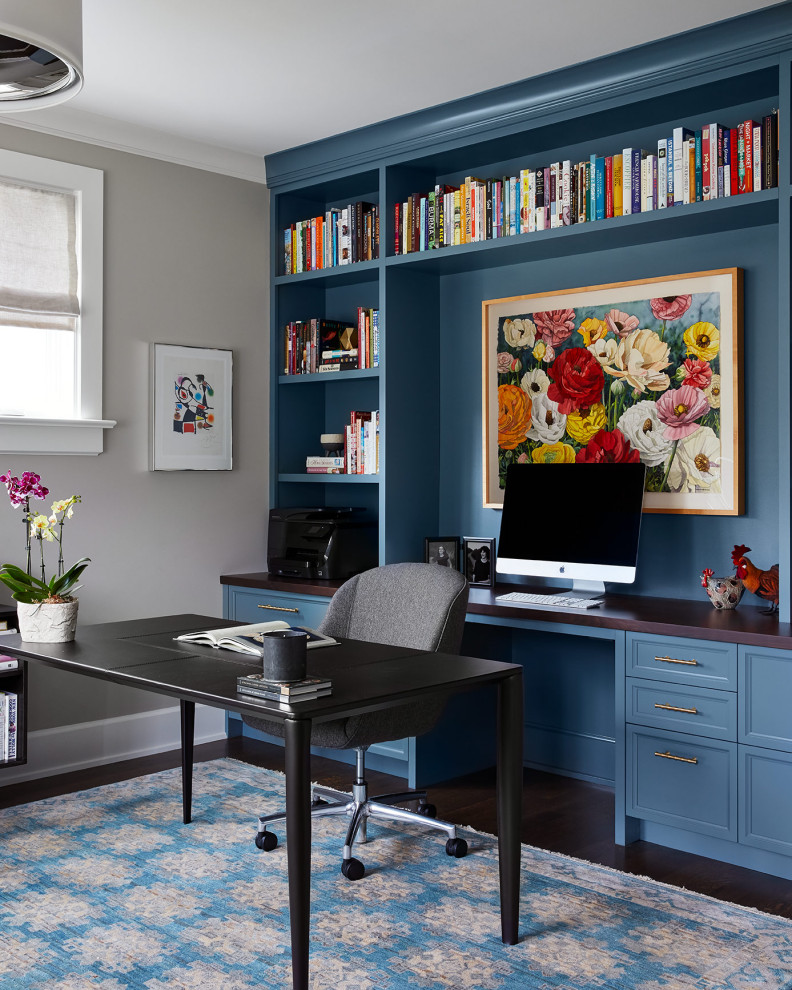 Photo of a country home office in Chicago with grey walls, dark hardwood floors, a freestanding desk and brown floor.