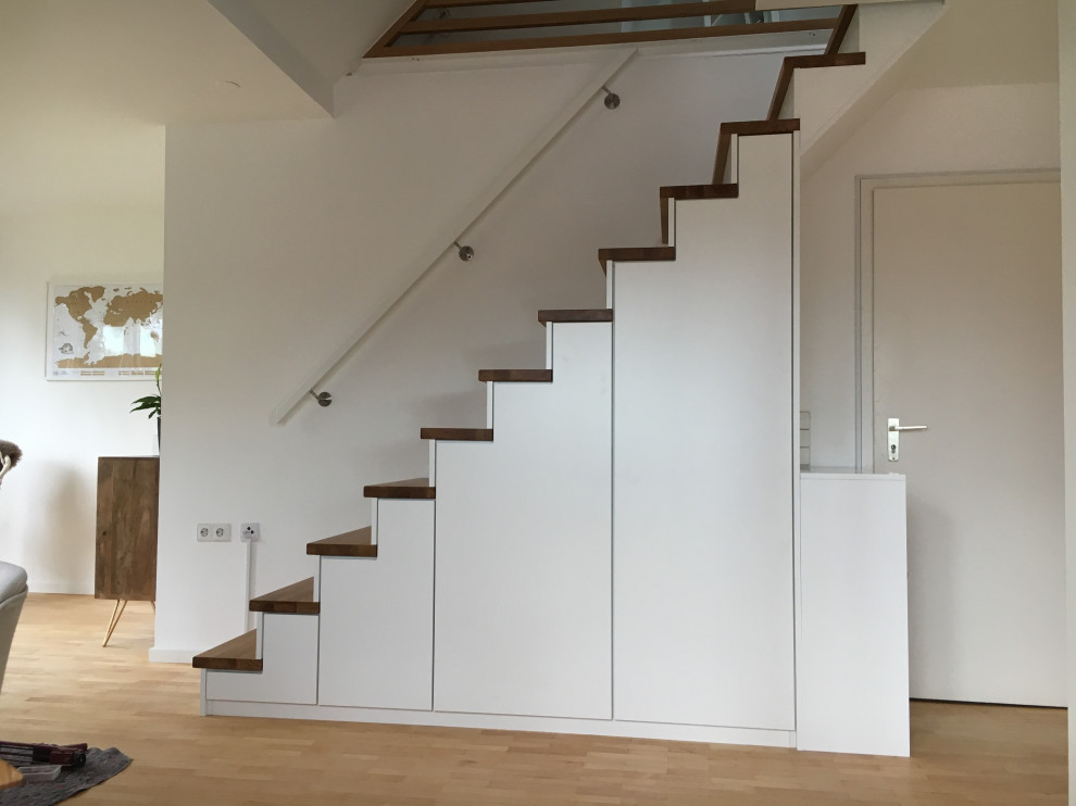 Photo of a contemporary wood straight staircase in Stuttgart with wood risers and wood railing.