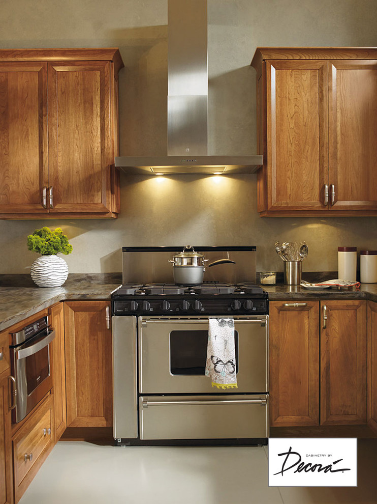 Eat-in kitchen - small l-shaped eat-in kitchen idea with medium tone wood cabinets, stainless steel appliances, a peninsula and gray countertops