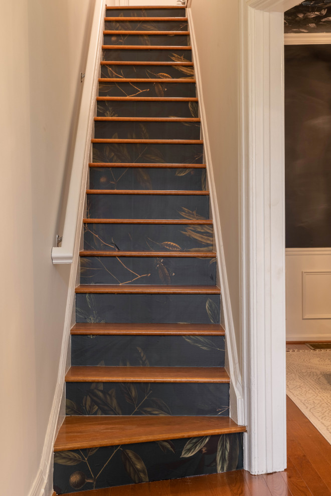 Photo of a small classic wood straight wood railing staircase in DC Metro with painted wood risers and wallpapered walls.