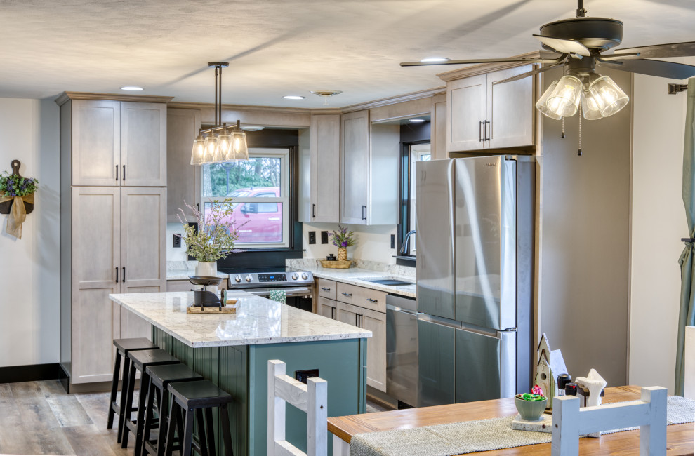 Mid-sized country open plan kitchen in Baltimore with an undermount sink, beaded inset cabinets, green cabinets, granite benchtops, white splashback, granite splashback, stainless steel appliances, vinyl floors, with island, multi-coloured floor and white benchtop.