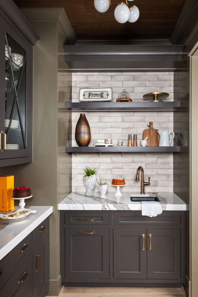 This is an example of a small modern kitchen pantry in DC Metro with a submerged sink, recessed-panel cabinets, brown cabinets, engineered stone countertops, white splashback, porcelain splashback, light hardwood flooring, an island, white worktops and a wood ceiling.
