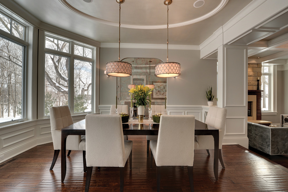 Mid-sized transitional open plan dining in New York with beige walls, medium hardwood floors, no fireplace and brown floor.