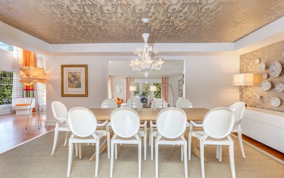 This is an example of a transitional dining room in New York with white walls.