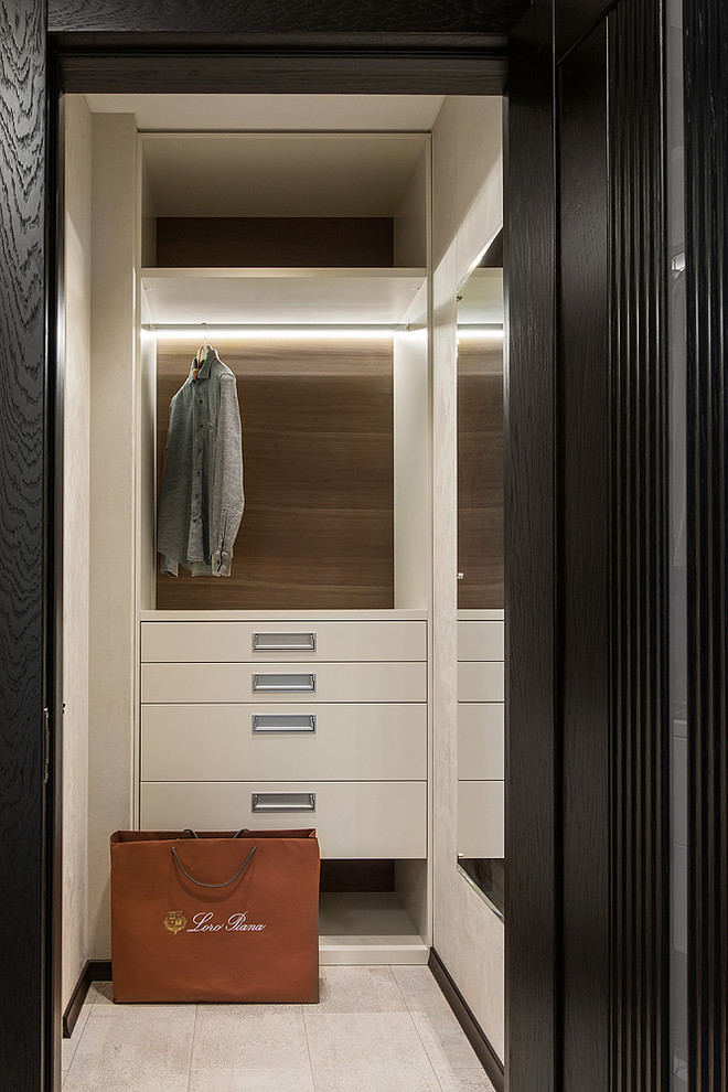 Photo of a small contemporary men's walk-in wardrobe in Saint Petersburg with flat-panel cabinets, beige cabinets, cork floors and white floor.
