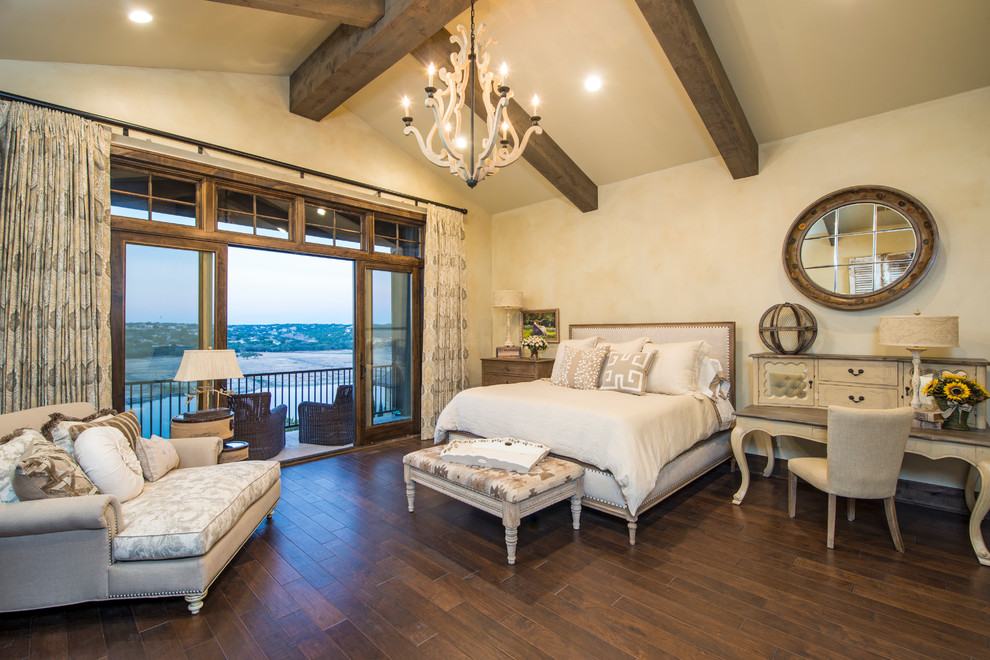 This is an example of a country bedroom in Austin with beige walls and dark hardwood floors.