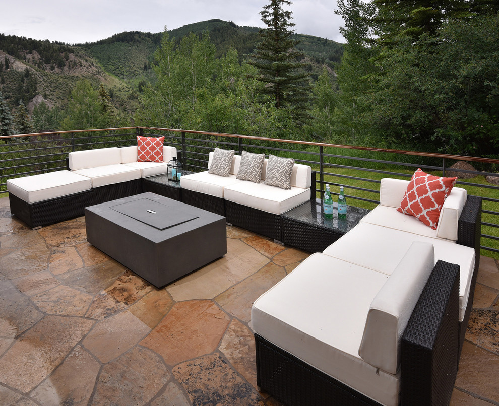Photo of a large contemporary backyard deck in Denver with a fire feature and no cover.