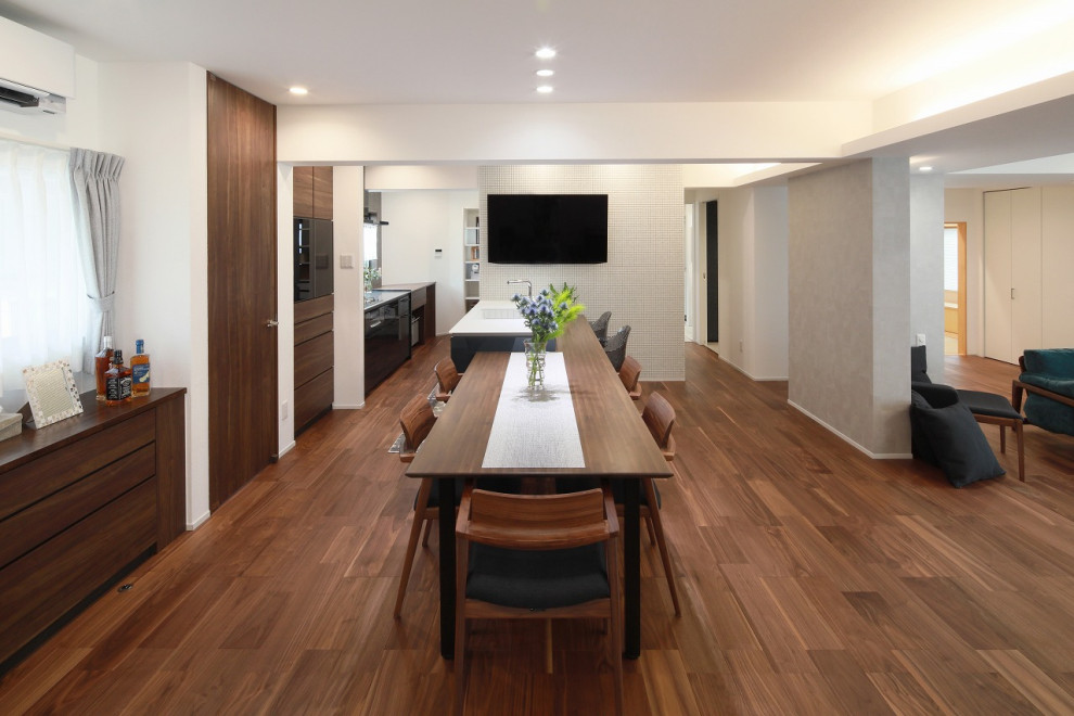 Modern open plan dining in Other with white walls, medium hardwood floors and wallpaper.