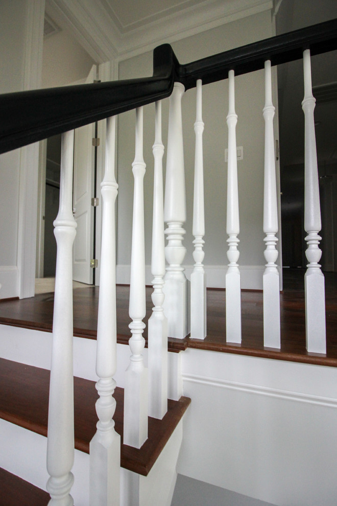 Large transitional wooden floating wood railing staircase photo in DC Metro with wooden risers