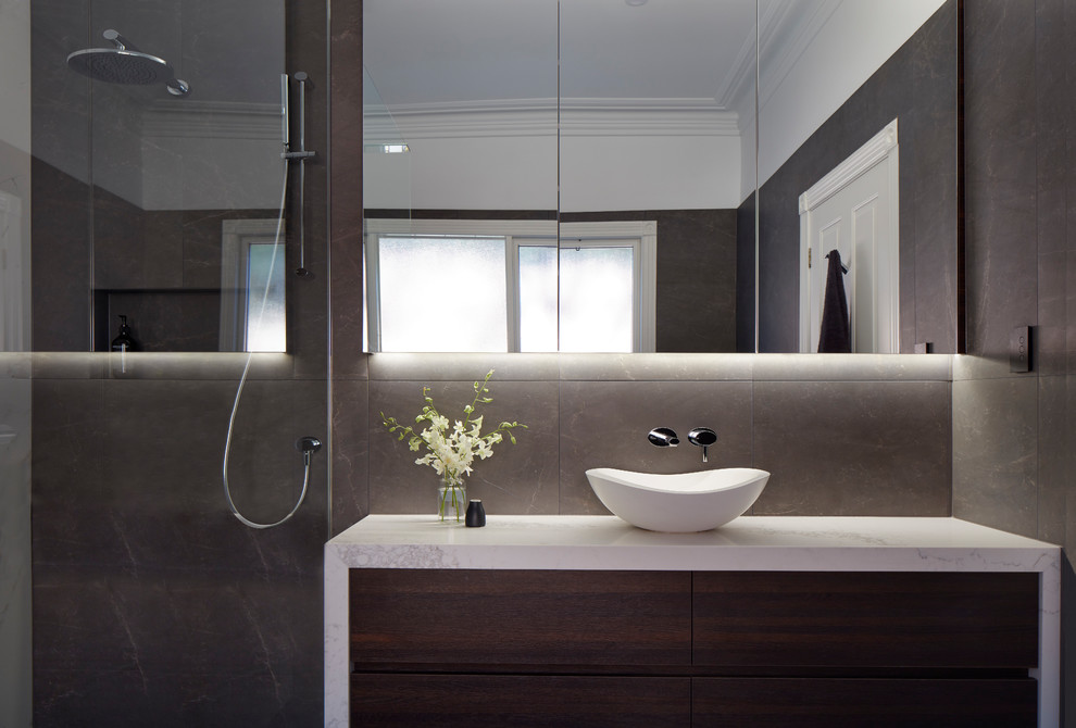 Photo of a large contemporary master bathroom in Melbourne with flat-panel cabinets, dark wood cabinets and marble benchtops.