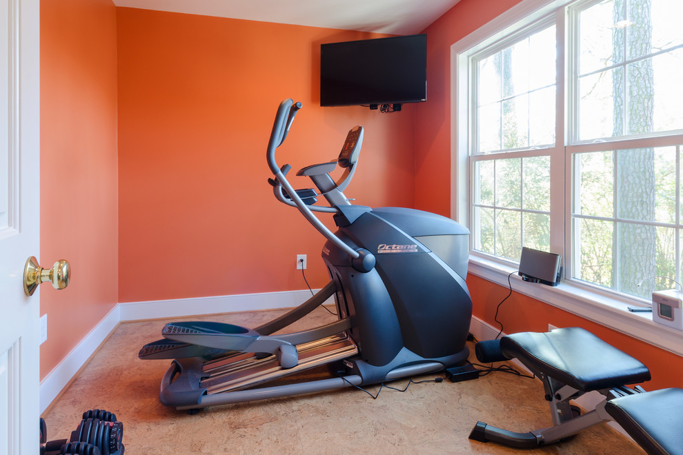 Mid-sized traditional multipurpose gym in Richmond with orange walls and brown floor.