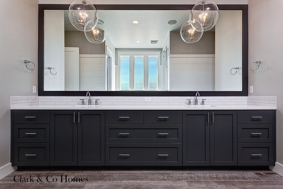 Large country master bathroom in Boise with an undermount sink, recessed-panel cabinets, grey cabinets, engineered quartz benchtops, a freestanding tub, an open shower, white tile, subway tile, grey walls and porcelain floors.