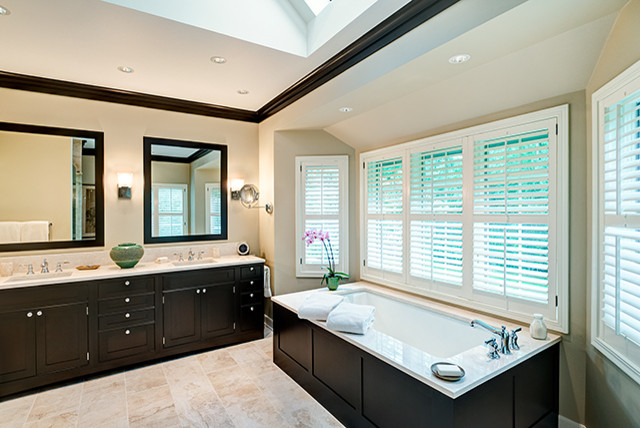 Large eclectic master bathroom in Chicago with an integrated sink, flat-panel cabinets, dark wood cabinets, marble benchtops, an undermount tub, beige tile, ceramic tile, beige walls, ceramic floors, an alcove shower and a two-piece toilet.