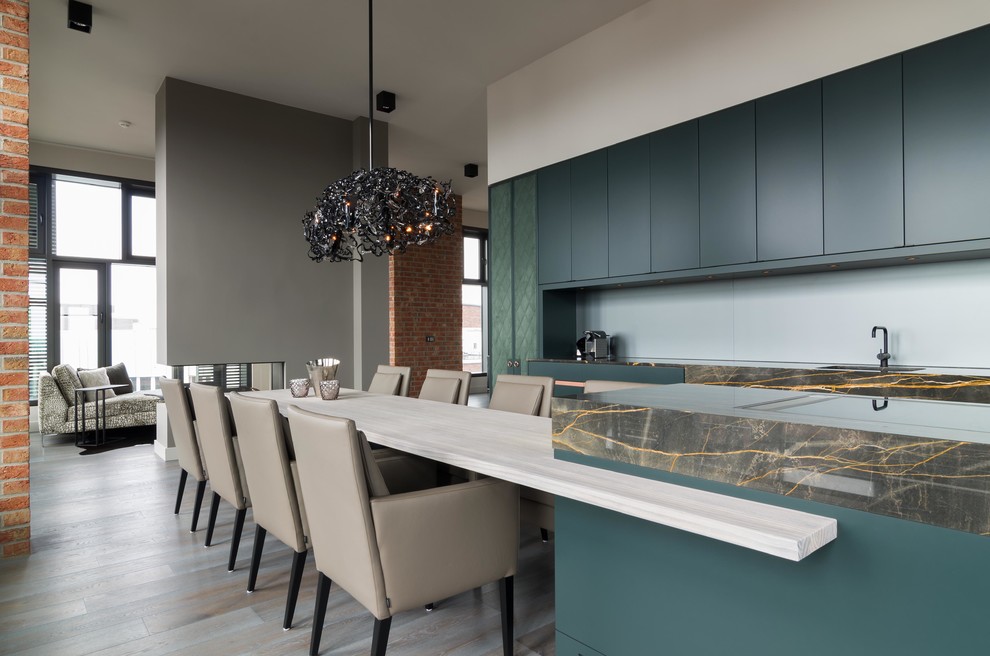 Inspiration for a large industrial galley open plan kitchen in Hamburg with a single-bowl sink, flat-panel cabinets, green cabinets, marble benchtops, green splashback and with island.