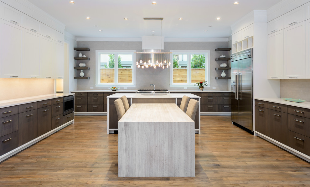 Design ideas for a large contemporary u-shaped eat-in kitchen in Dallas with a double-bowl sink, flat-panel cabinets, dark wood cabinets, grey splashback, stone tile splashback, stainless steel appliances, medium hardwood floors, multiple islands and solid surface benchtops.