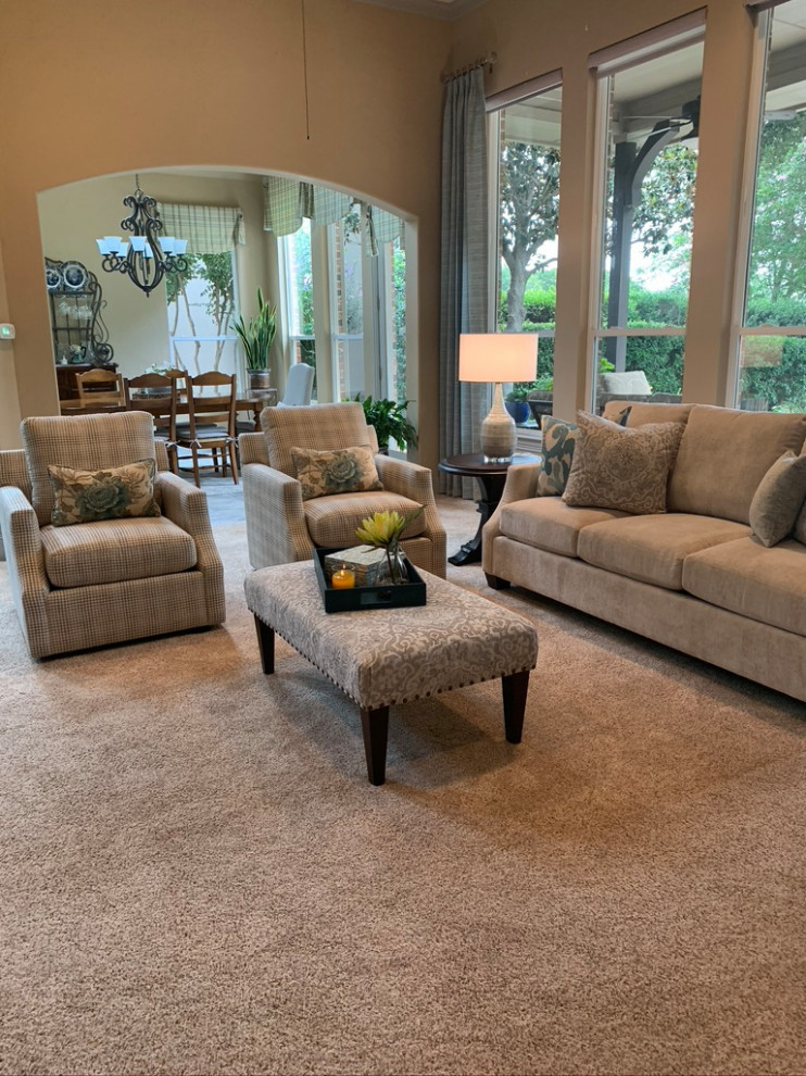 Photo of a mid-sized transitional open concept family room in Dallas with beige walls, carpet, a corner fireplace, a stone fireplace surround, a built-in media wall and beige floor.