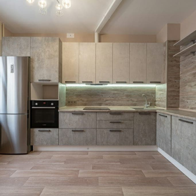This is an example of a medium sized urban grey and white l-shaped kitchen/diner in Moscow with a built-in sink, recessed-panel cabinets, white cabinets, wood worktops, brown splashback, wood splashback, integrated appliances, medium hardwood flooring, no island, beige floors, brown worktops and feature lighting.