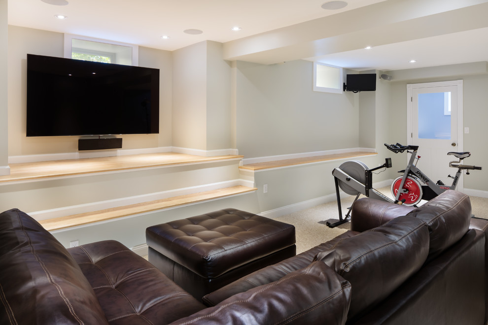This is an example of a mid-sized transitional home weight room in Boston with grey walls and carpet.