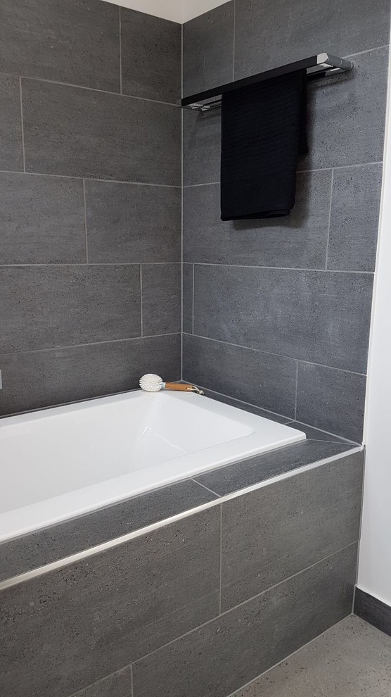 Photo of a mid-sized contemporary master bathroom in Geelong with flat-panel cabinets, white cabinets, an alcove tub, a curbless shower, ceramic tile, grey walls, terrazzo floors, a vessel sink, wood benchtops, grey floor and a hinged shower door.