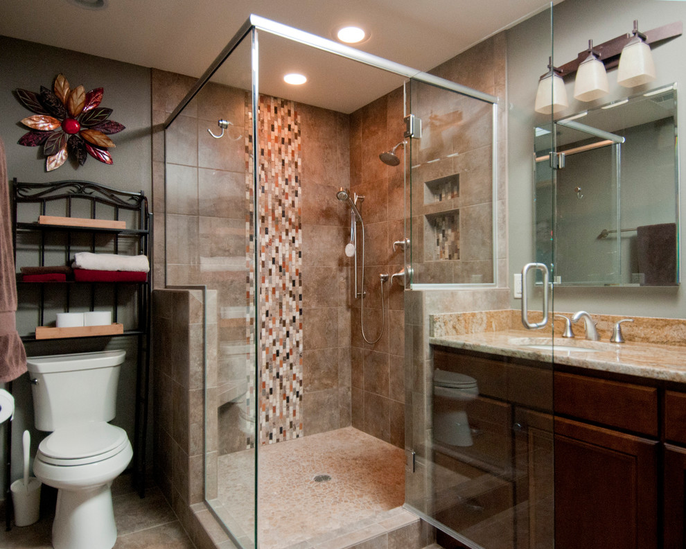 Inspiration for a mid-sized transitional master beige tile and porcelain tile porcelain tile corner shower remodel in Milwaukee with an undermount sink, recessed-panel cabinets, medium tone wood cabinets, granite countertops, a two-piece toilet and gray walls