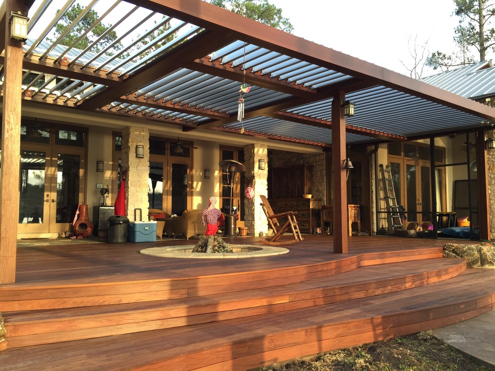 Inspiration for a large modern backyard deck in Houston with a fire feature and a pergola.