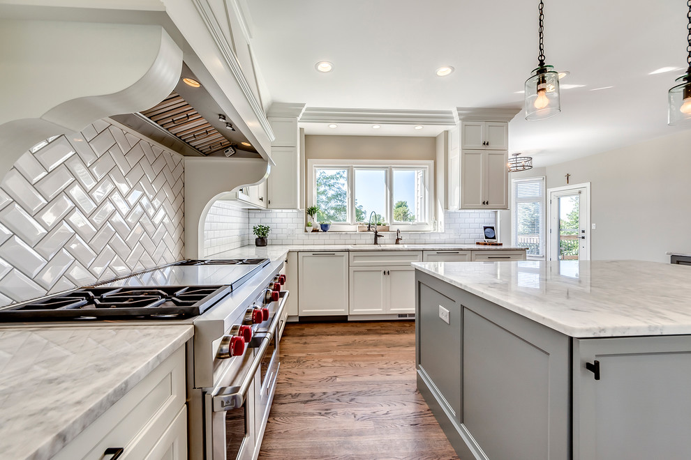 Open concept kitchen - transitional open concept kitchen idea in Chicago with white backsplash, subway tile backsplash and two islands