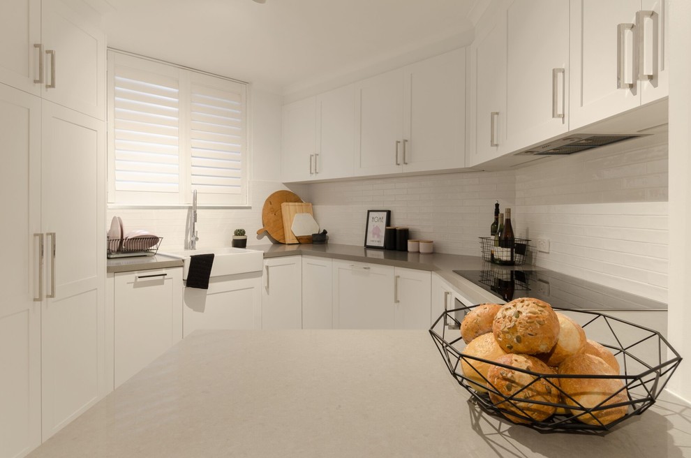 This is an example of a contemporary kitchen in Sydney with shaker cabinets and white cabinets.