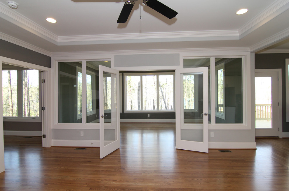 This is an example of a large contemporary sunroom in Raleigh with light hardwood floors, no fireplace and a standard ceiling.