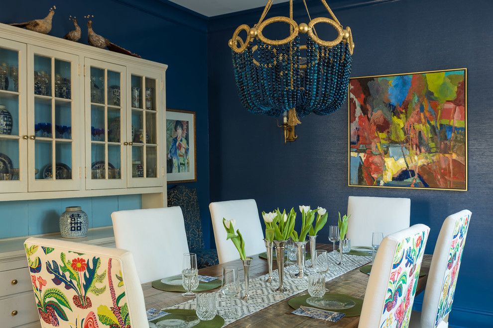 This is an example of a mid-sized eclectic separate dining room in Charlotte with blue walls.