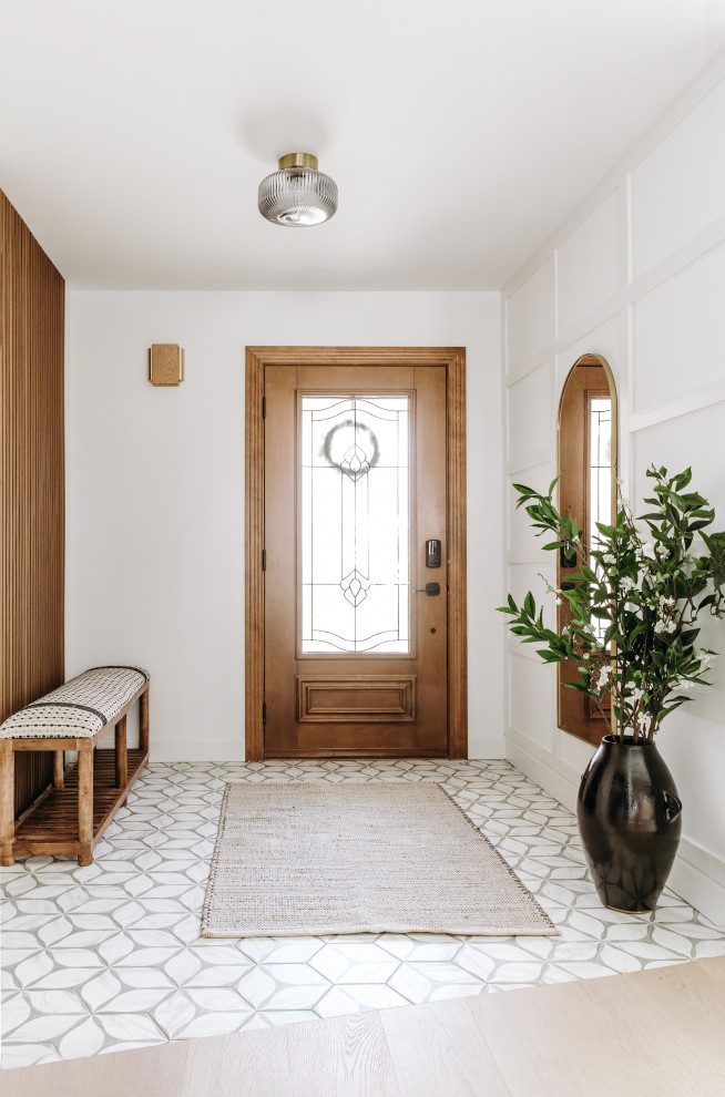 Inspiration for a mid-sized transitional light wood floor, beige floor and wall paneling entryway remodel in Toronto with white walls