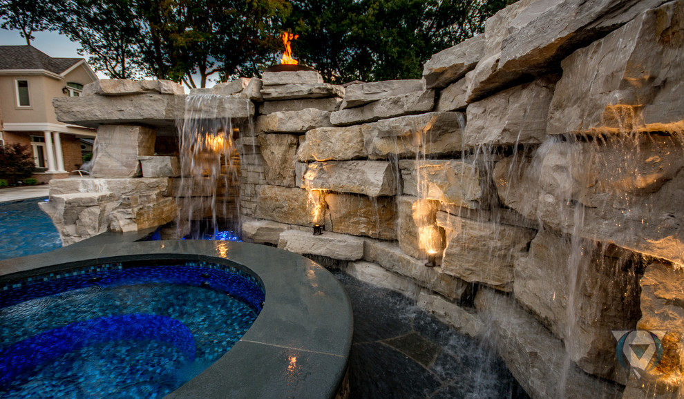 Inspiration for a large rustic backyard stone and rectangular natural pool fountain remodel in Chicago
