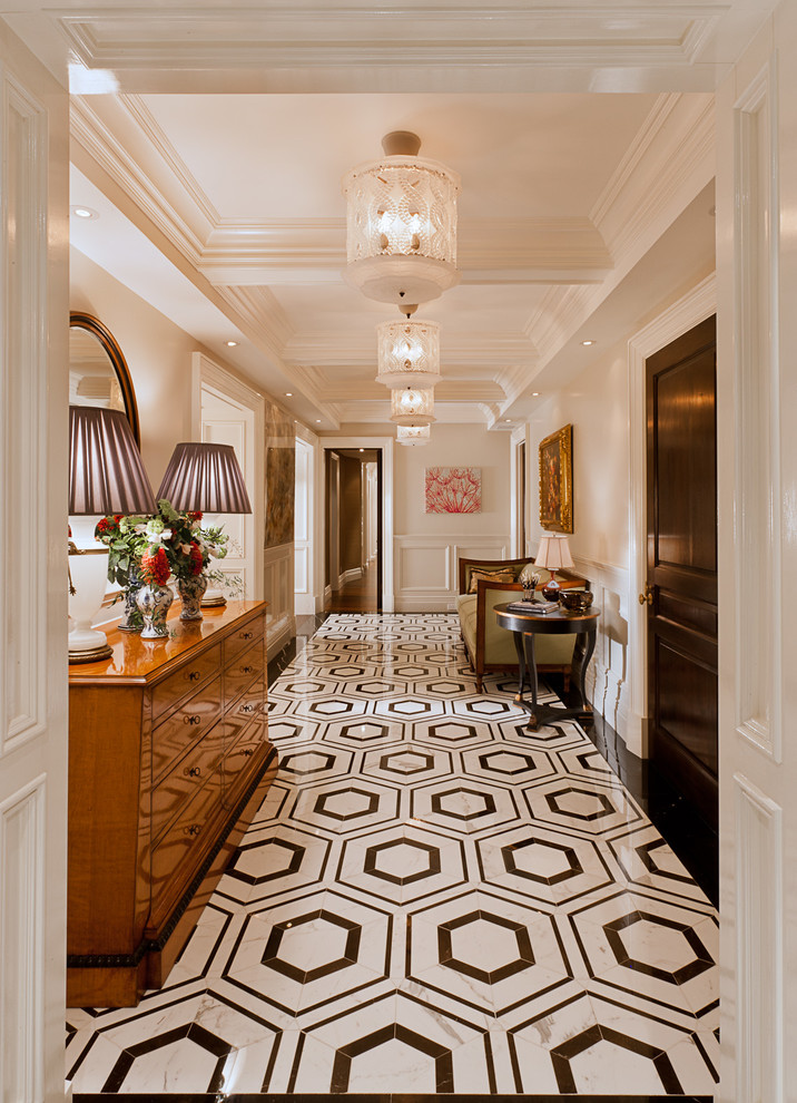 This is an example of a traditional entry hall in New York with white walls and multi-coloured floor.