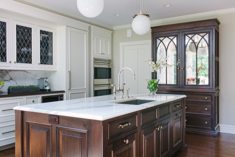 Inspiration for a large transitional galley eat-in kitchen in Chicago with an undermount sink, beaded inset cabinets, white cabinets, marble benchtops, white splashback, stone slab splashback, stainless steel appliances, dark hardwood floors and with island.