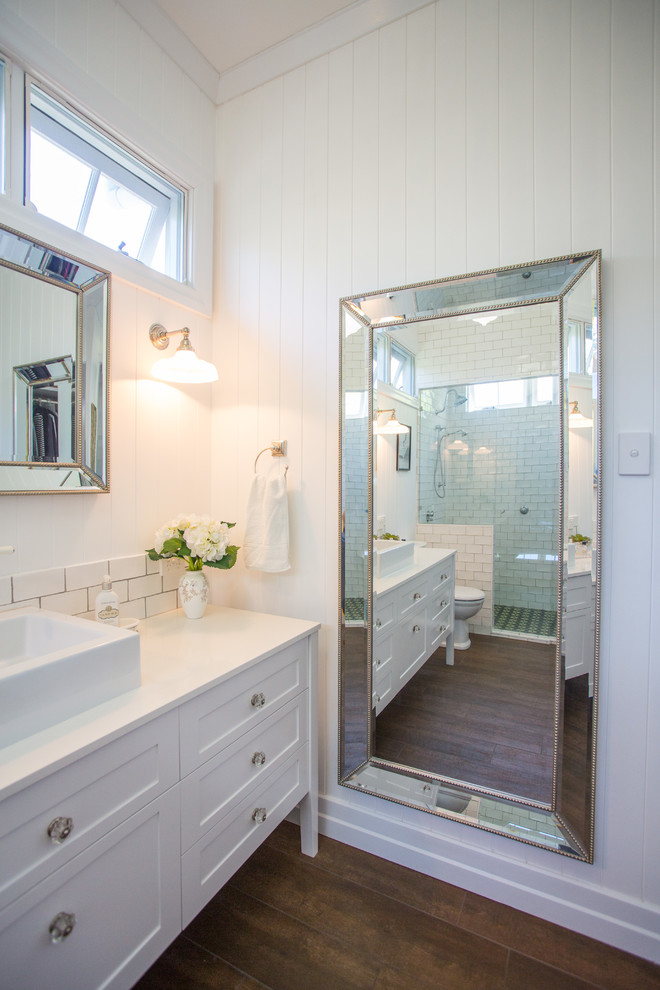 Inspiration for a large traditional master bathroom in Brisbane with furniture-like cabinets, white cabinets, a curbless shower, a one-piece toilet, white tile, subway tile, white walls, a vessel sink and engineered quartz benchtops.