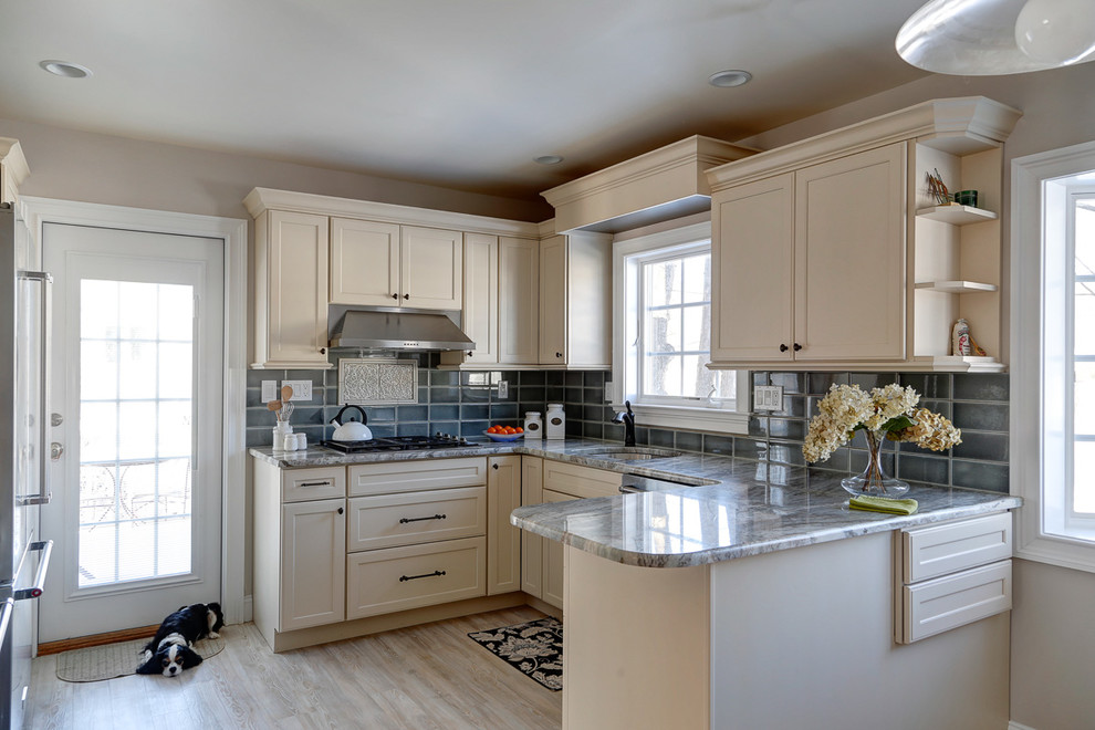 Mid-sized transitional u-shaped separate kitchen in New York with an undermount sink, shaker cabinets, beige cabinets, granite benchtops, green splashback, subway tile splashback, stainless steel appliances, vinyl floors and a peninsula.