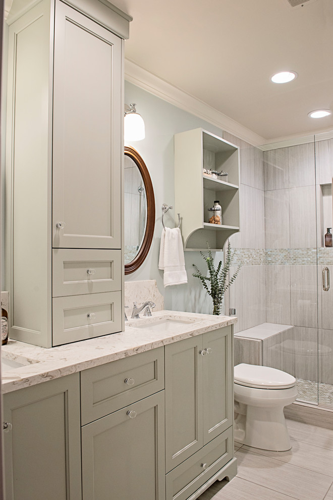 Mid-sized traditional 3/4 bathroom in Nashville with recessed-panel cabinets, green cabinets, an alcove shower, a one-piece toilet, gray tile, ceramic tile, blue walls, ceramic floors, an undermount sink, quartzite benchtops, grey floor, a hinged shower door and multi-coloured benchtops.