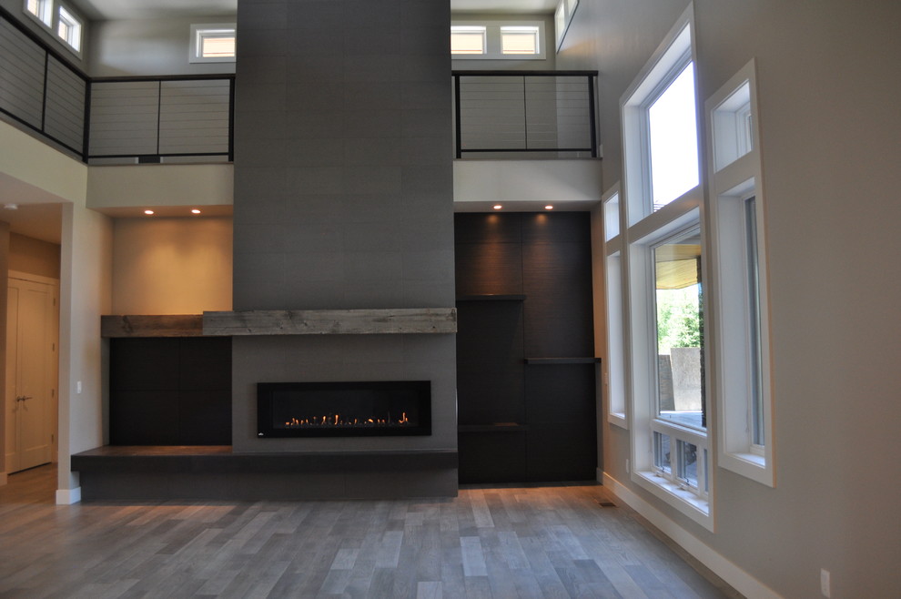 Large contemporary formal living room in Other with grey walls, medium hardwood floors, a tile fireplace surround and a standard fireplace.