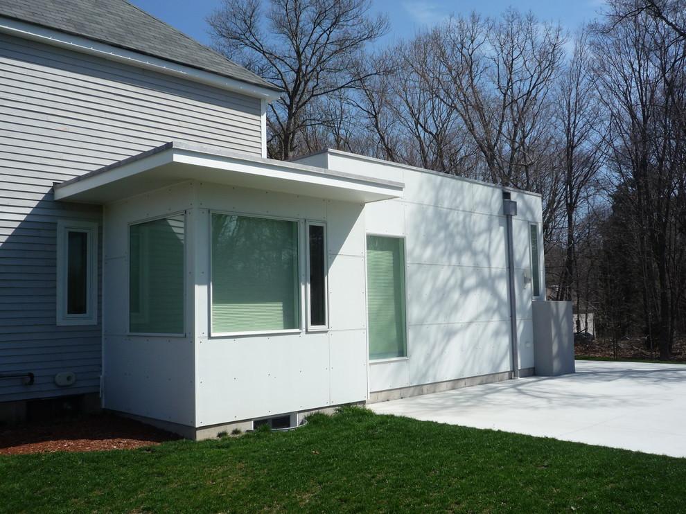 This is an example of a contemporary one-storey white exterior in Other with concrete fiberboard siding.