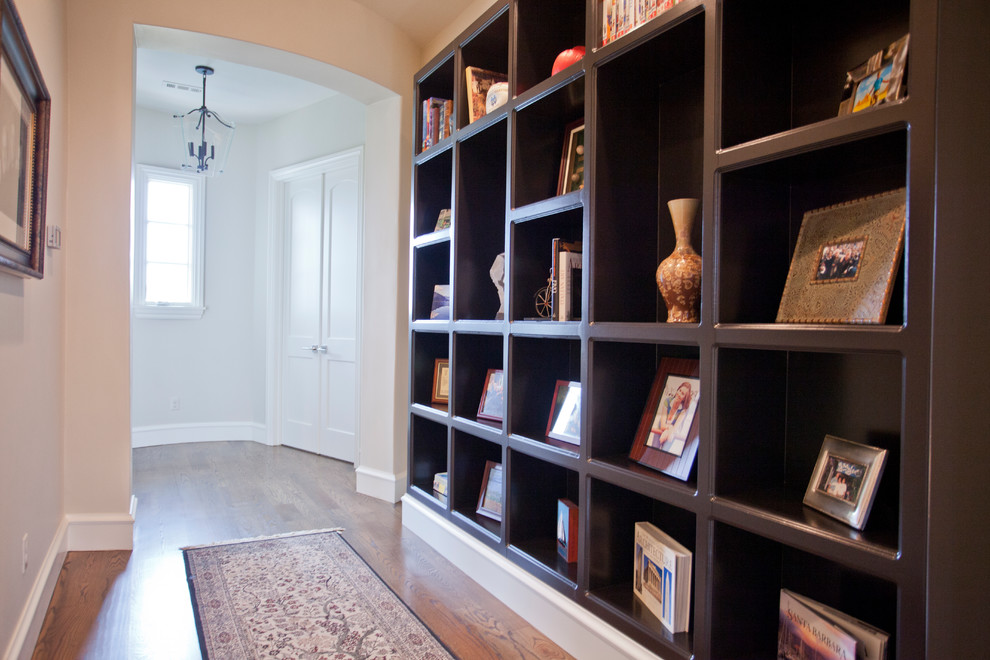 This is an example of a mid-sized mediterranean hallway in Other with beige walls, medium hardwood floors and brown floor.