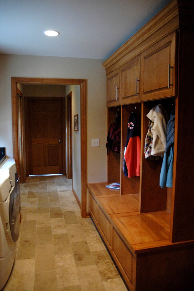 Design ideas for a mid-sized traditional mudroom in Milwaukee with limestone floors, beige walls and beige floor.