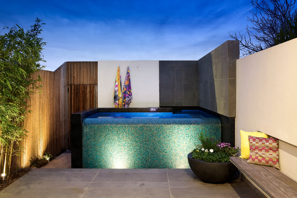 Design ideas for a contemporary backyard rectangular pool in Melbourne with a hot tub and concrete pavers.