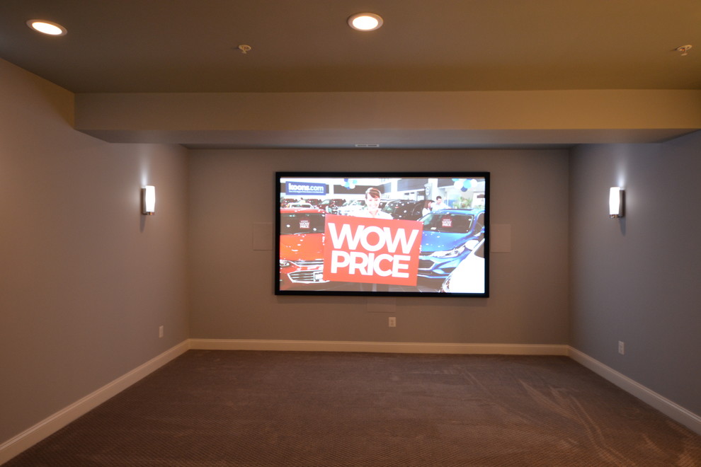 Photo of a mid-sized transitional enclosed home theatre in Baltimore with blue walls, carpet, a projector screen and brown floor.
