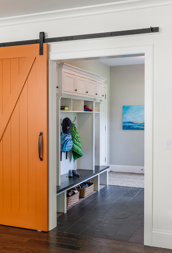 Design ideas for a traditional mudroom in Minneapolis with an orange front door and white walls.