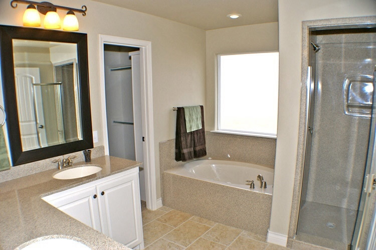 Mid-sized traditional master bathroom in Albuquerque with raised-panel cabinets, white cabinets, an undermount tub, an alcove shower, beige tile, beige walls, limestone floors, an undermount sink, beige floor, a hinged shower door, granite benchtops and beige benchtops.
