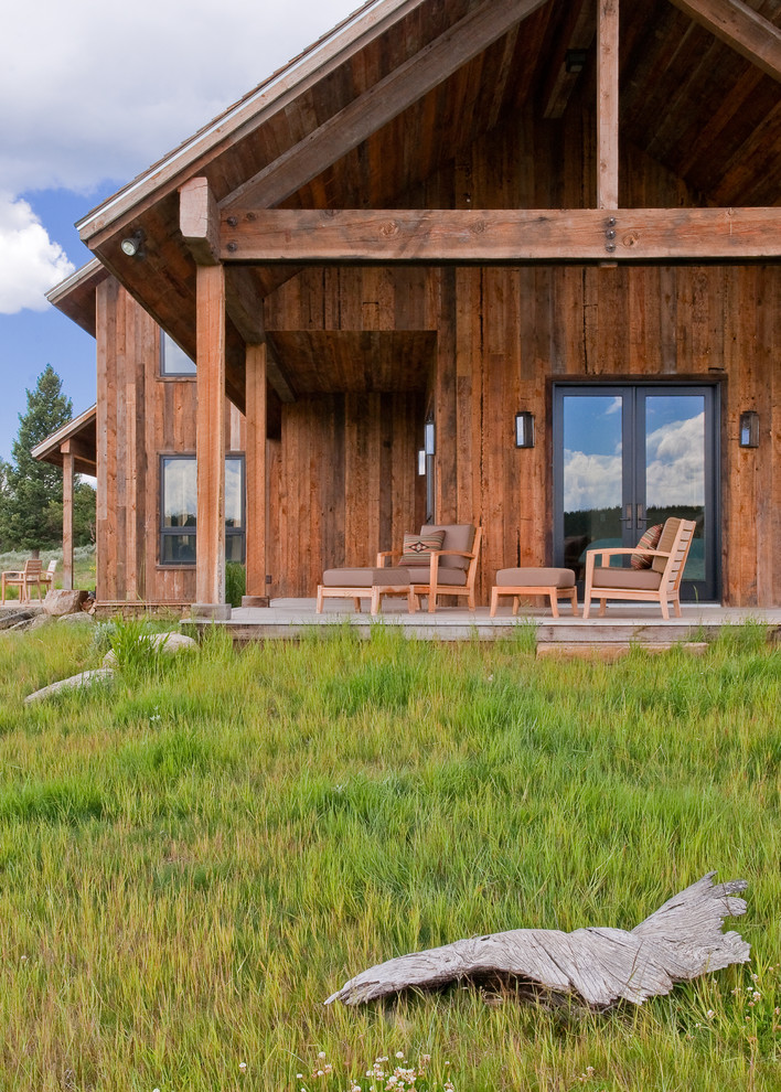 Inspiration for a rustic porch remodel in Other with decking and a roof extension